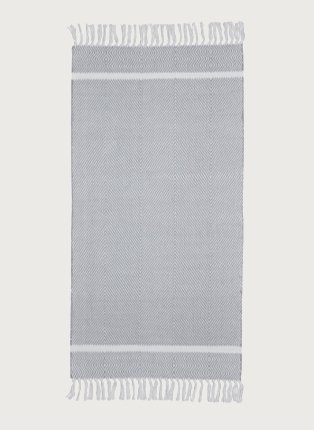 Grey herringbone tassel rug.