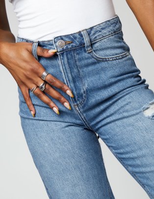 Woman in white vest and jeans.