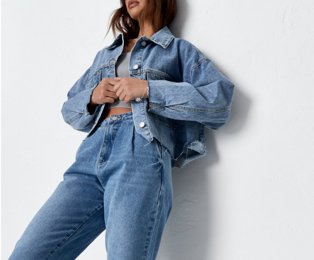 Woman wearing denim jacket and denim jeans.