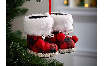 Pair of red tartan boots hanging on a Christmas tree
