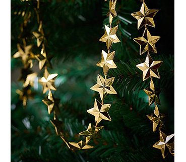 Gold star-shaped Christmas ribbon on a tree