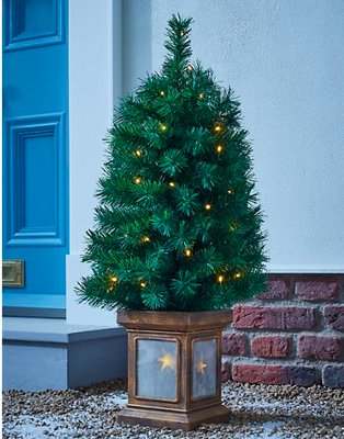 3ft green pre-lit Christmas tree outside house.