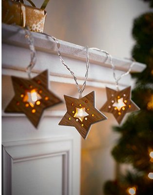 White mantlepiece features wooden-effect star-shaped decorative lights.