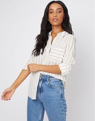 Woman wearing relaxed fit jeans with a striped shirt
