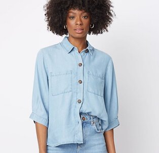 Woman wearing light wash relaxed fit jeans with a blue shirt