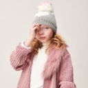 Girl wearing white top and pink chenille cardigan with a grey and white hat