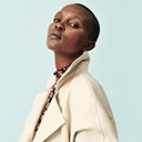 Woman posing wearing cream trench coat