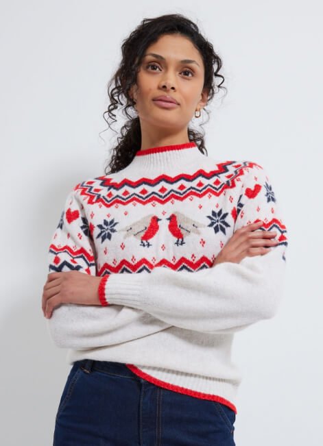 Woman poses wearing Christmas jumper.