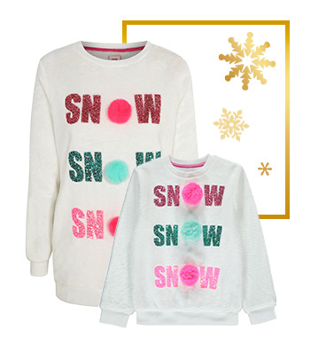 This jumper comes with glittery lettering and fun pom-poms