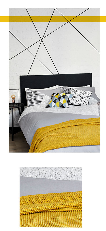 Refresh your bedroom with monochrome bedding and a yellow textured throw