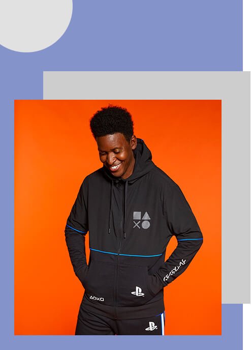 A smiling man wearing a black Playstation hoodie.