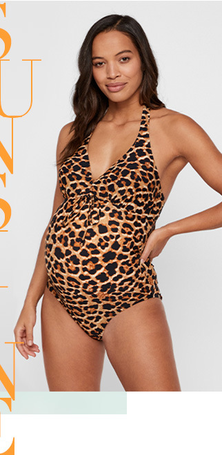 Pregnant woman wearing a leopard print swimsuit