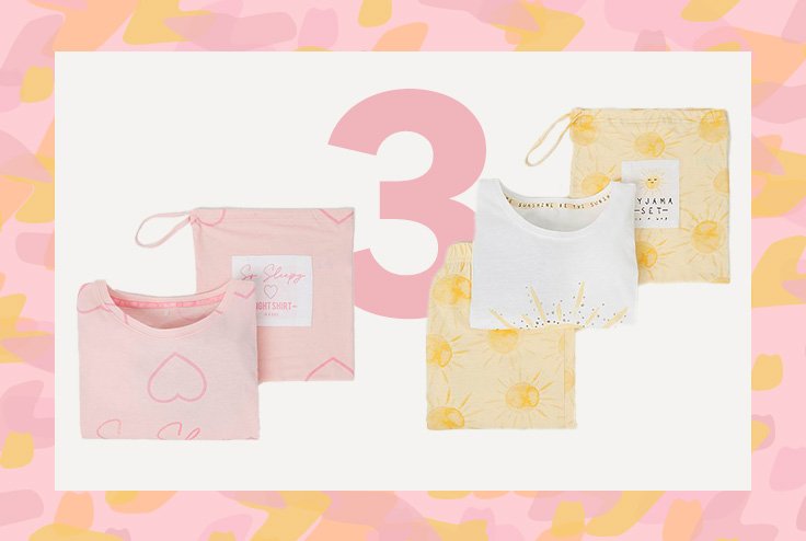 Folded pink heart print nightdress with bag and folded yellow sunshine print pyjamas with bag.