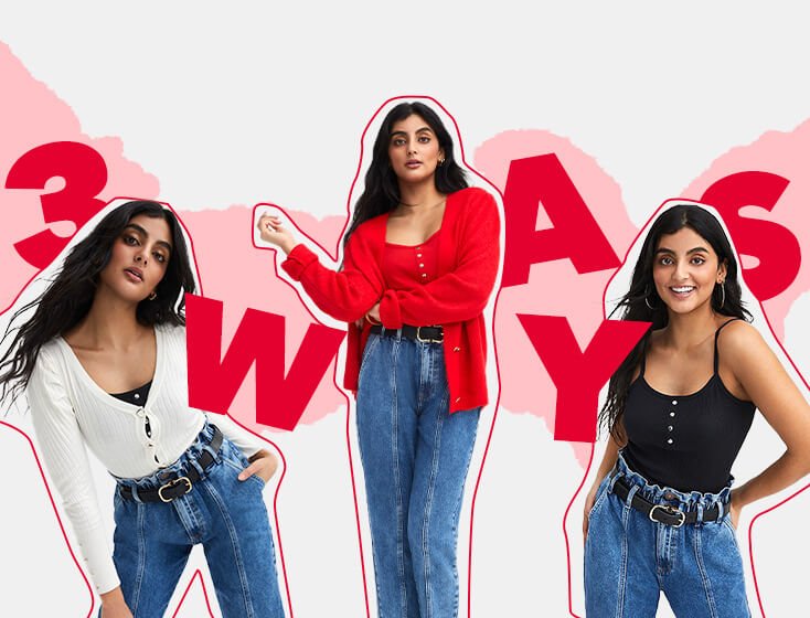 Woman leans to one side with hand on hip wearing blue denim elasticated waist jeans with black belt with gold-tone buckle, black ribbed cami body and white button down v-neck cardigan, woman poses with arm across waist wearing red ribbed cami body, red ribbed knit heart button cardigan and blue denim elasticated waist jeans with black belt with gold-tone buckle, woman poses smiling wearing black button detail vest top and blue denim elasticated waist jeans with black belt with gold-tone buckle. 