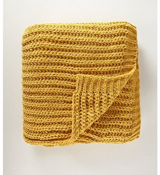 A yellow knitted throw