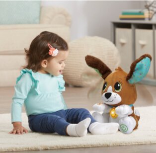 Child sitting with soft toy.