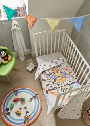 Baby's room with cot, Mickey Mouse blanket, play mat and toys.