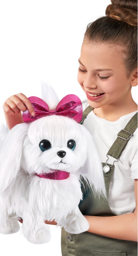A child playing with a white dog toy.