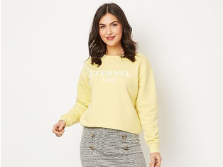 Woman wearing lemon yellow 'Éternel Love' slogan sweatshirt and button detail checked jacquard skirt