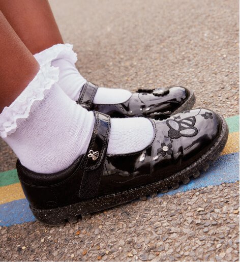 Girls patent school shoes and frill socks.