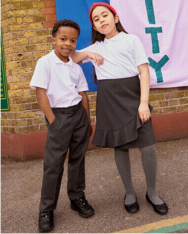 Children wearing white school polos and trousers and skirts.