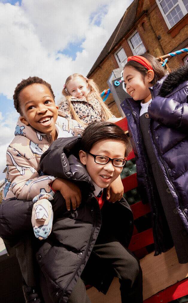 A group of children wearing school coats.