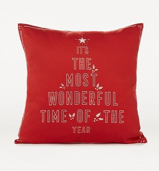 Red Christmas slogan print cushion.