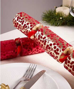 White tablecloth with metallic red and gold crackers.