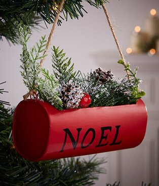 Red Noel hanging basket bauble placed on Chrismas tree.