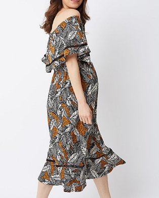Woman wearing multicoloured midi maternity dress with an off the shoulder detail