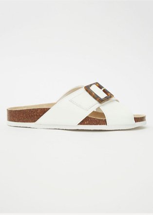 Product shot of white crossover sandals with tortoiseshell buckle detail