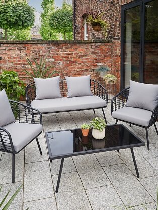 An outdoor sofa, armchair and coffee table set.