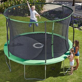 Three children playing with a green trampoline.