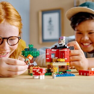 Two children playing with a Lego playset.