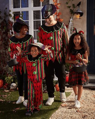 A family of four trick-or-treating in matching clown costumes.
