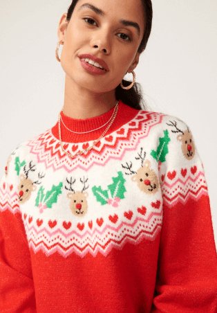 A woman in a red Christmas reindeer print knitted jumper