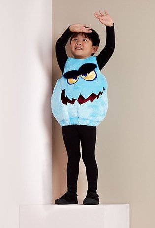 A boy with his hands up wearing a blue faux fur Monster Tabard costume
