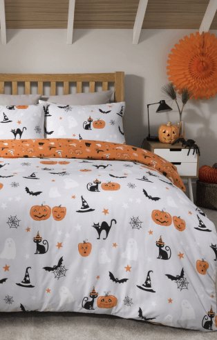 A bedroom with Halloween decor and a double bed with a Halloween pumpkin duvet set.