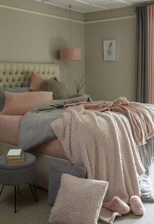 Bedroom setting with grey and pink bedding.