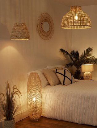 Bedroom setting with rattan lamp shades and mirror.