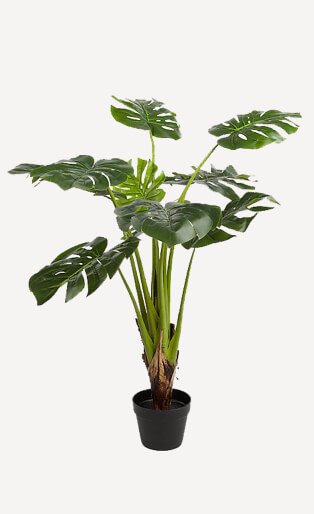 Artificial green plant in black pot