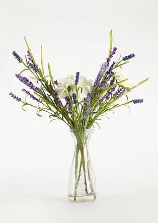 Glass vase containing artificial flowers and grasses, including lavender