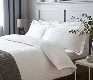 Double bed with white striped bedding