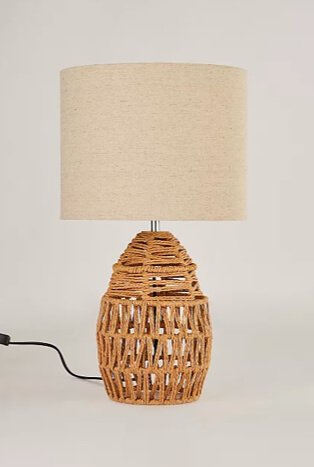 Rattan table lamp with cream shade.