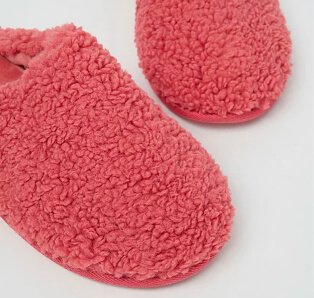 Pink borg fleece mule slippers.