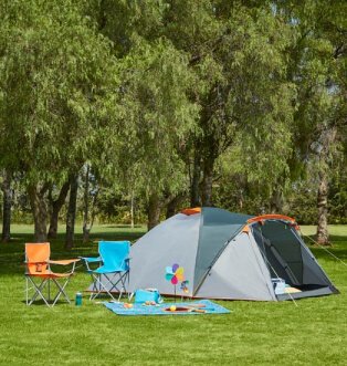 Grey and orange tent with orange and teal camping chairs.