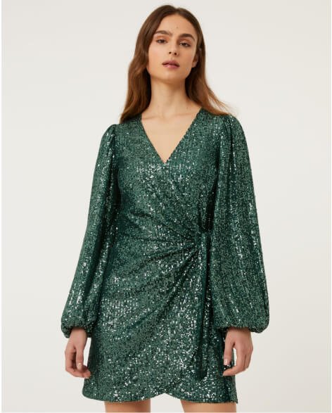 A woman wearing a sparkly green dress.