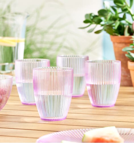 Pink, pearlescent glasses on a garden table.