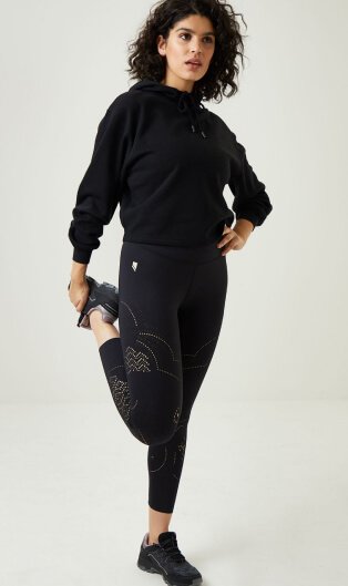 Woman wearing black jumper and sports tights.
