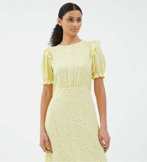 A woman wearing a yellow floral fit and flare midi dress